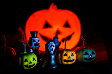 Halloween still life with pumpkin lights and devil