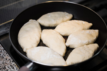 Frying fresh pies on a gas stove