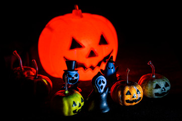 Halloween still life with pumpkin lights and devil