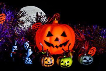 Halloween still life with pumpkin lights and devil