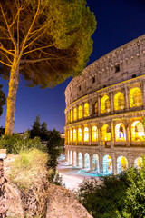 The Colosseum in Rome, Italy at sunset twilight. Blue hour photo in the evening. The world famous...
