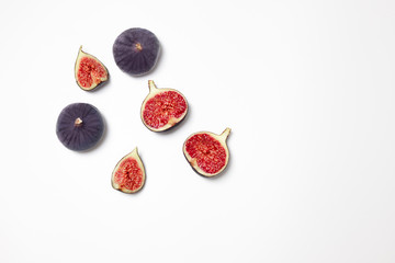 Fresh figs isolated on white background with space for text. Food Photo. Copy space. Purple figs with red seeds. Flat lay, top view