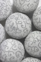 Christmas background. White Christmas balls with silver pattern closeup. Beautiful Christmas Wallpaper.