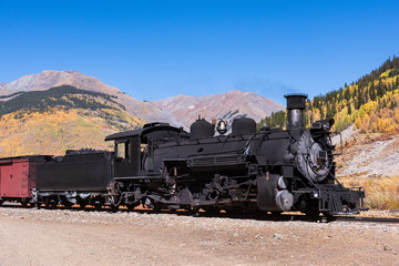 Obraz premium Vintage Steam Train With Autumn Scenery Background.