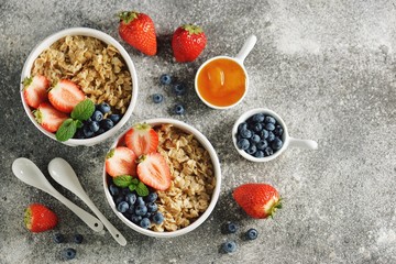 Oatmeal porridge with organic blueberries, strawberries, honey and mint.