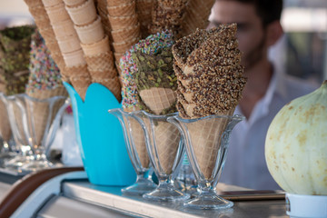 Close up of ice cream cones and next to melon and water bottle.Close up of chocolate ice cream cones and next to it is melon and water bottle.