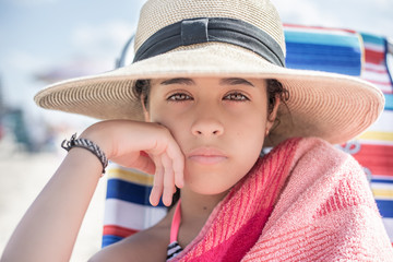 Portrait of girl wearing  a hat at the beach