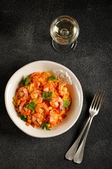 Paella or risotto with shrimp tails, carrots, onions, bell peppers, white wine and chicken stock. 