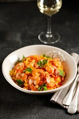 Paella or risotto with shrimp tails, carrots, onions, bell peppers, white wine and chicken stock. 