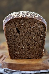 Healthy rye bread with organic milk and butter on an old wooden background.