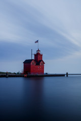 long exposure lighthouse in harbor on cloudy day