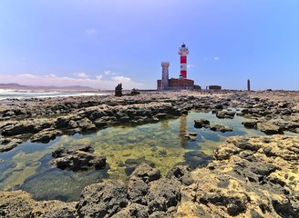 Fototapeta na wymiar Toston lighthouse in El Cotillo at Fuerteventura Canary Islands