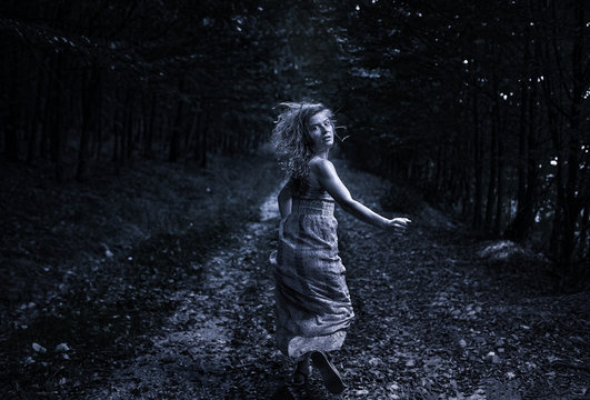 Scared Girl Running Through Forest