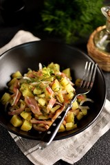 Smoked pork ears salad with boiled potatoes, pickles, onions, dill and olive oil.