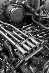 Fototapeta premium Engine of fighter jet with fuel pipes, hydraulic and other equipment, army aviation, military aircraft and aerospace industry, selective focus, monochrome shot
