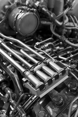 Engine of fighter jet with fuel pipes, hydraulic and other equipment, army aviation, military aircraft and aerospace industry, selective focus, monochrome shot