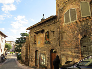Old brick houses and wooden windows in Assisi, Italy