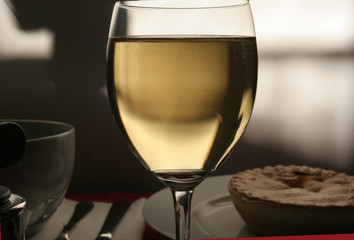 White wine glass on the table in an evening atmosphere