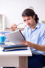 Young male employee working at home