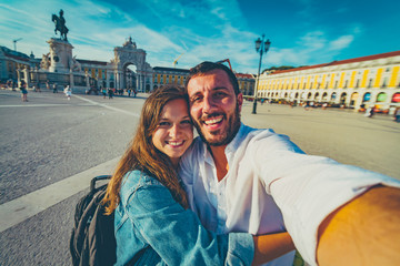 happy tourist traveling in Lisbon, taking selfie photo in the most important site of Lisbon,...