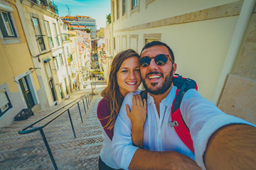 happy tourist traveling in Lisbon, taking selfie photo in the most important site of Lisbon,...