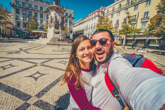 happy tourist traveling in Lisbon, taking selfie photo in the most important site of Lisbon, capital of Portugal
