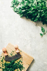 How to series cooking 101 guide, how to cut parsley, top view of fresh parsley on a cutboard with...