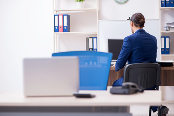 Young male businessman working in the office