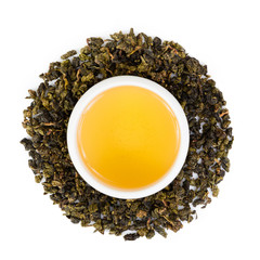 cup of tea with green leaves isolated on white background