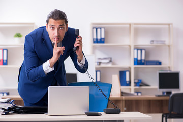 Young male businessman working in the office