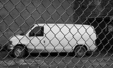 car locked by a fence wall