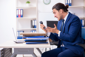 Young male businessman working in the office