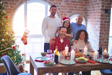 Beautiful family smiling happy and confident. Posing with tree celebrating Christmas at home