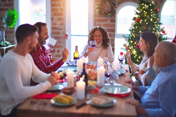 Beautiful family smiling happy and confident. Eating roasted turkey celebrating Christmas at home