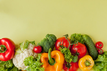 Healthy clean eating layout, vegetarian food and diet nutrition concept. Various fresh vegetables ingredients for salad on yellow table background, top view, frame, banner.