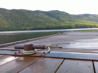 Fototapeta premium Rusty iron port bollard with rolled rope