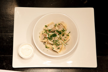 spaghetti with sauce and basil on white plate