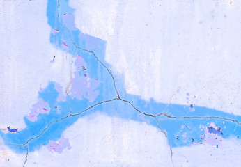 Cracked blue surface with various shades of blue paint.