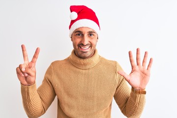 Young handsome man wearing christmas and turtleneck sweater over isolated background showing and...