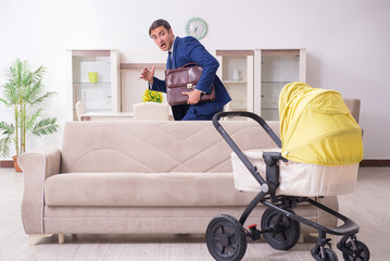 Young businessman looking after baby