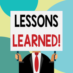 Handwriting text writing Lessons Learned. Conceptual photo experiences distilled project that should actively taken Just man chest dressed dark suit tie no face holding blank big rectangle