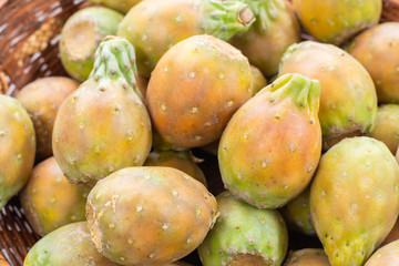 Basket filled with delicious prickly pear fruits or prickly pear fruit, top view