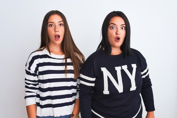 Young beautiful women wearing casual clothes standing over isolated white background afraid and shocked with surprise expression, fear and excited face.