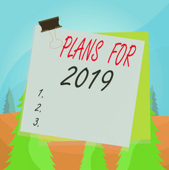 Word writing text Plans For 2019. Business photo showcasing an intention or decision about what one is going to do Paper stuck binder clip colorful background reminder memo office supply