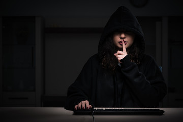 Female hacker hacking security firewall late in office