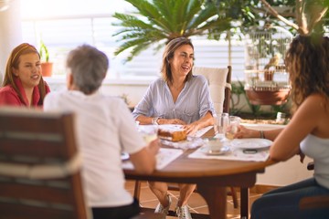Young beautiful girl smiling happy and confident sitting dinking cup of coffee at terrace