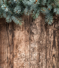Christmas fir branches on wooden background. Xmas and New Year holiday. Flat lay, top view