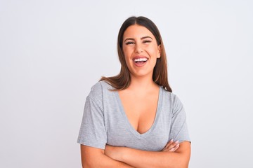 Fototapeta premium Portrait of beautiful young woman standing over isolated white background happy face smiling with crossed arms looking at the camera. Positive person.