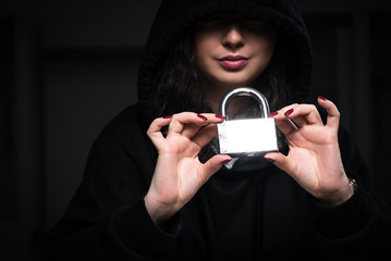 Female hacker hacking security firewall late in office
