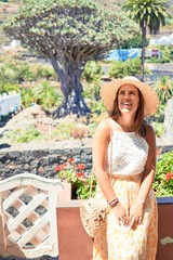 Young beatiful woman smiling happy and cheerful at Drago Milenario park on a sunny day of summer on Tenerife